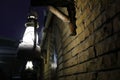 View of glowing lantern on wall of brick building Royalty Free Stock Photo