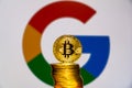 Gold Bitcoin coins with the Google logo on background Royalty Free Stock Photo