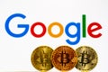 Gold Bitcoin coins with the Google logo on background Royalty Free Stock Photo