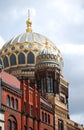 View on the golden towers of the Berlin synagogue under blue sky.