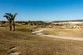 View of a golf course with golf cart path under clear blue skies Royalty Free Stock Photo
