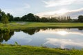 View of Golf Course with fairway and pond at sunset, Golf course with a rich green turf beautiful scenery, Green grass and woods Royalty Free Stock Photo