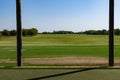 View from a golf driving range tee box flanked by two posts Royalty Free Stock Photo