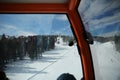 View from gondola cabins of cableway lift on winter snowy mountains background beautiful scenery
