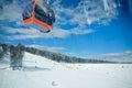 View from gondola cabins of cableway lift on winter snowy mountains background beautiful scenery Royalty Free Stock Photo