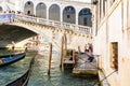 View of gondolas on Grand canal and Ponte di Rialto, many tourists on a bridge Royalty Free Stock Photo