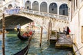 View of gondolas on Grand canal and Ponte di Rialto, many tourists on a bridge Royalty Free Stock Photo