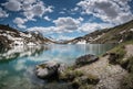 Gorgeous mountain lake in the Alps with reflections and snow remnants