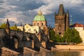 View on gothic Old Town Bridge Tower and Charles bridge over Vltava river under storm clouds Royalty Free Stock Photo
