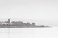 View of Gourock town in Inverclyde near Greenock in dull wet bad winter weather silhouette of village buildings and church