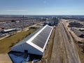 grain storage building with solar panels and grain bins in the background Royalty Free Stock Photo