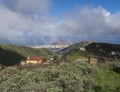 View of Gran Canaria landscape from a hill with Galdar town, Montana de Ajodar, red roof country house and winding road Royalty Free Stock Photo