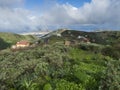 View of Gran Canaria landscape from a hill with Galdar town, Montana de Ajodar, red roof country house and winding road Royalty Free Stock Photo