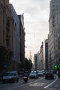 View of Gran via street at sunset flanked by historic buildings on both sides