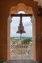 View of the Granada city through the arch of the bell tower of L