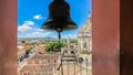 View of the Granada city through the arch of the bell tower of La Merced Church along the street Calle Real Xalteva with Iglesia Royalty Free Stock Photo