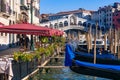 View of the Grand Canal, Rialto Bridge, and gondolas from outdoor restaurant seats, Venice