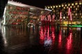 A view of Grand Canal Square at night in Dublin`s regenerated Docklands with red columns standing randomly. Ireland September 201