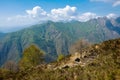 View of grand mountains with ruins of historic structure on a sunny day