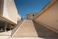 View of the grand stone staircase in the old town of Valetta, Malta. Part of the parliament building on the side. The sky is blue Royalty Free Stock Photo