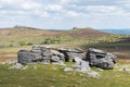 View of the granite bedrock outcrops at Top Tor, Dartmoor National Park, Devon, UK, on a bright cloudy day