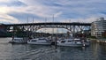 View of Granville Street Bridge in Vancouver downtown spanning False Creek bay with marina and yacht boats in front.