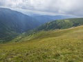 View from grassy hill slopes of hiking trail from Chopok at mountain meadow landscape of ridge Low Tatras mountains Royalty Free Stock Photo