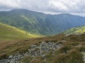 View from grassy hill slopes of hiking trail from Chopok at mountain meadow landscape of ridge Low Tatras mountains Royalty Free Stock Photo