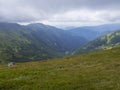 View from grassy hill slopes of hiking trail from Chopok at mountain meadow landscape of ridge Low Tatras mountains Royalty Free Stock Photo