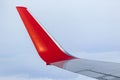 View of the gray sky from the height of flight above the clouds from the window of the plane in the bright sun