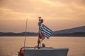 View of a Greek flag with the sunset in the background. Royalty Free Stock Photo