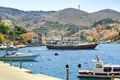 View on Greek sea Symi island harbor port, classical ship yachts, houses on island hills, tourists Aegean Sea bay. Greece islands