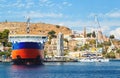 View on Greek sea Symi island harbor port, classical ship yachts, houses on island hills, tourists Aegean Sea bay Royalty Free Stock Photo