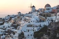 View on Greek village with wind mill and flag during sunset, Oia, Santorini, Greece Royalty Free Stock Photo