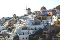 View on Greek village with wind mill with last sunbeams, Oia, Santorini, Greece Royalty Free Stock Photo