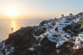 View on Greek village with wind mill during sunset with sail ship, Oia, Santorini, Greece Royalty Free Stock Photo