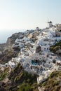 View on Greek village with wind mill during sunset vertical, Oia, Santorini, Greece Royalty Free Stock Photo