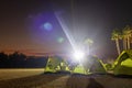 A view of a green canvas camping tent illuminated by floodlights set up on the lawn Royalty Free Stock Photo