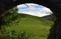 View of a Green Field through an Aqueduct Archway