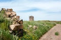 View with green field, rural landscape and old windmill. Beautiful scene on green country hill Royalty Free Stock Photo