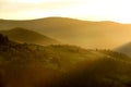 View of the green mountains in the early morning. rays of light illuminating valleys and hills.