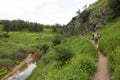 A view of green mountains and grass, dirt roads