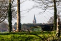 View from the green park of the top of church in a distance in Brecht, Belgium