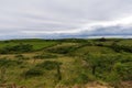 View of green pastures with cows, a cloudy afternoon, with the sea in the background, in Cantabria, Spain. Royalty Free Stock Photo