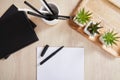 View of green plants, black notebooks