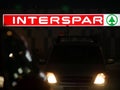 View of grocery store with glowing Interspar logo sign. Shopping. Grocery