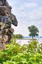 View from the grotto at Schwerin Castle on the Schwerin lake. On the horizon a tree and a sailboat