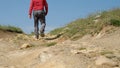 View from ground level of man walking rugged road of Nebrodi Park, Royalty Free Stock Photo