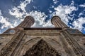 View from ground up the facade and the twin minarets of a mediev Royalty Free Stock Photo