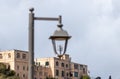 View of a group of antennas standing on the roof of a building through a street lamp in old district of Jerusalem city in Israel